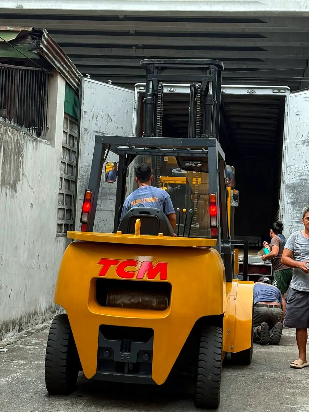 Perenne Trading crew backing a forklift into a delivery truck