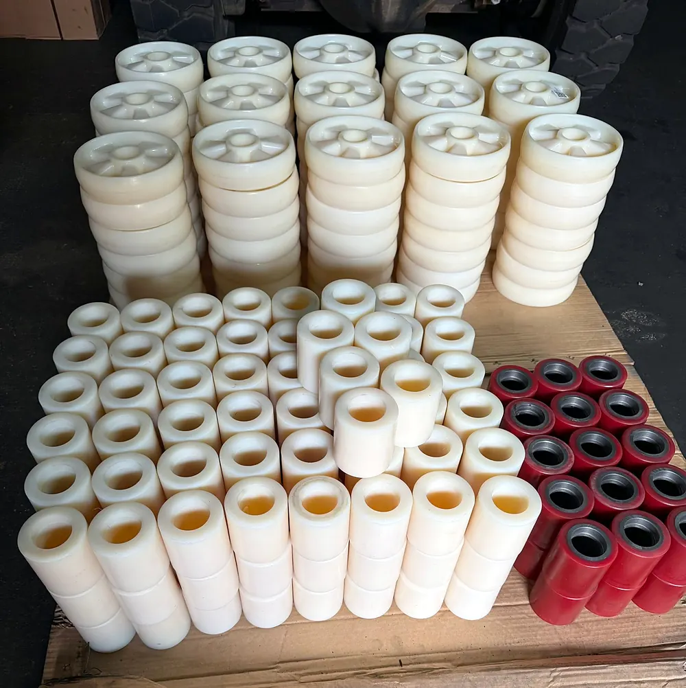 Pallet of white nylon and red polyurethane wheels and rollers for pallet jacks