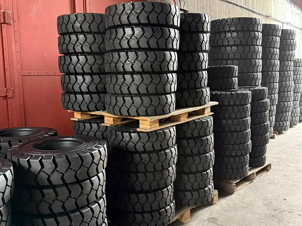 Stacks of solid forklift tyres on pallets inside the stockroom