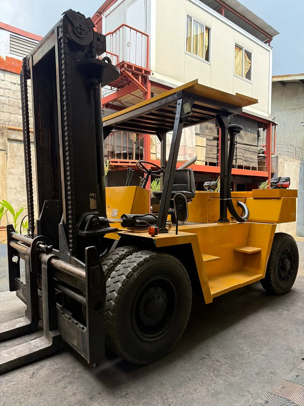 Heavy-duty TCM forklift with dual front wheels and a wide fork carriage